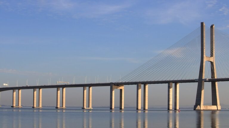 A very long, low cable-stayed bridge stretching across calm water.